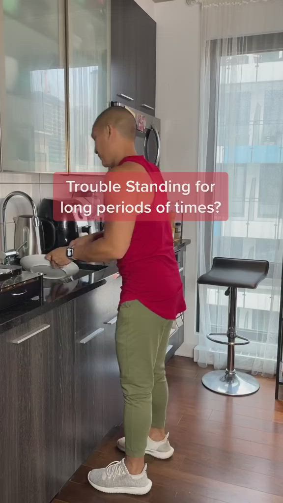 This may contain: a woman standing in front of a kitchen counter with the words trouble standing for long periods of times?