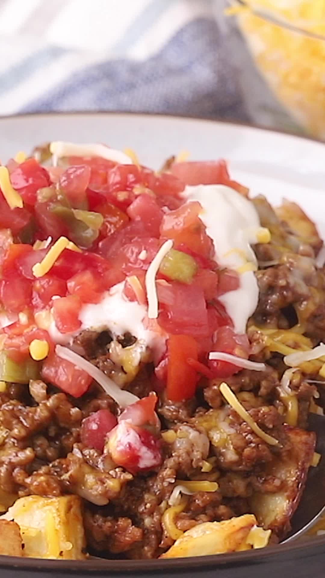 This contains: Video showing how to make taco potatoes.