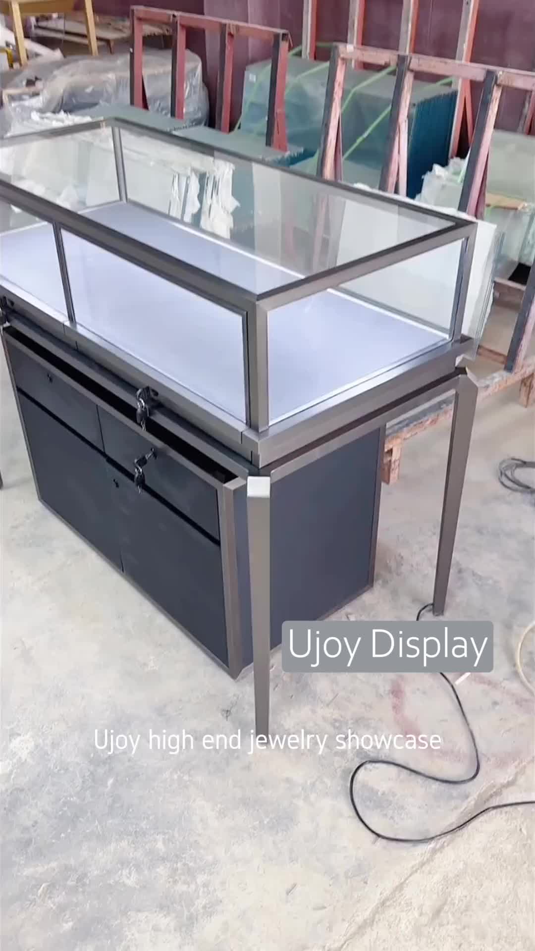 This may contain: a glass display case sitting on top of a table