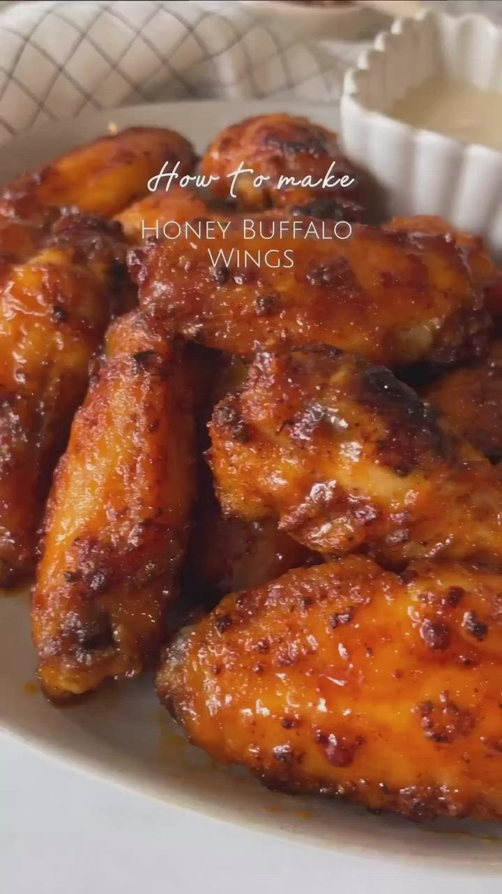 This contains: The recipe is easy to customize with your preferred level of heat and sweetness, making it perfect for a variety of taste preferences. Whether you're hosting a party or looking for a quick and easy dinner, these honey buffalo chicken wings are sure to be a hit. So head to Pinterest and check out the full recipe for honey buffalo chicken wings today!