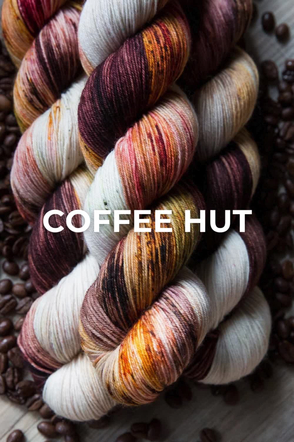 This may contain: several skeins of coffee with the words coffee hut on top of them in front of some coffee beans