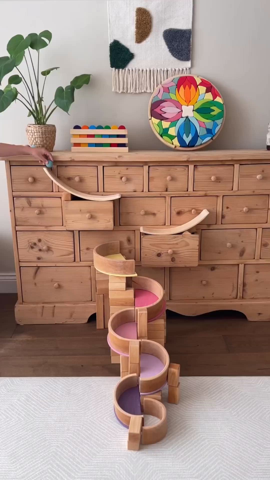 This may contain: a wooden dresser sitting next to a potted plant on top of a white rug