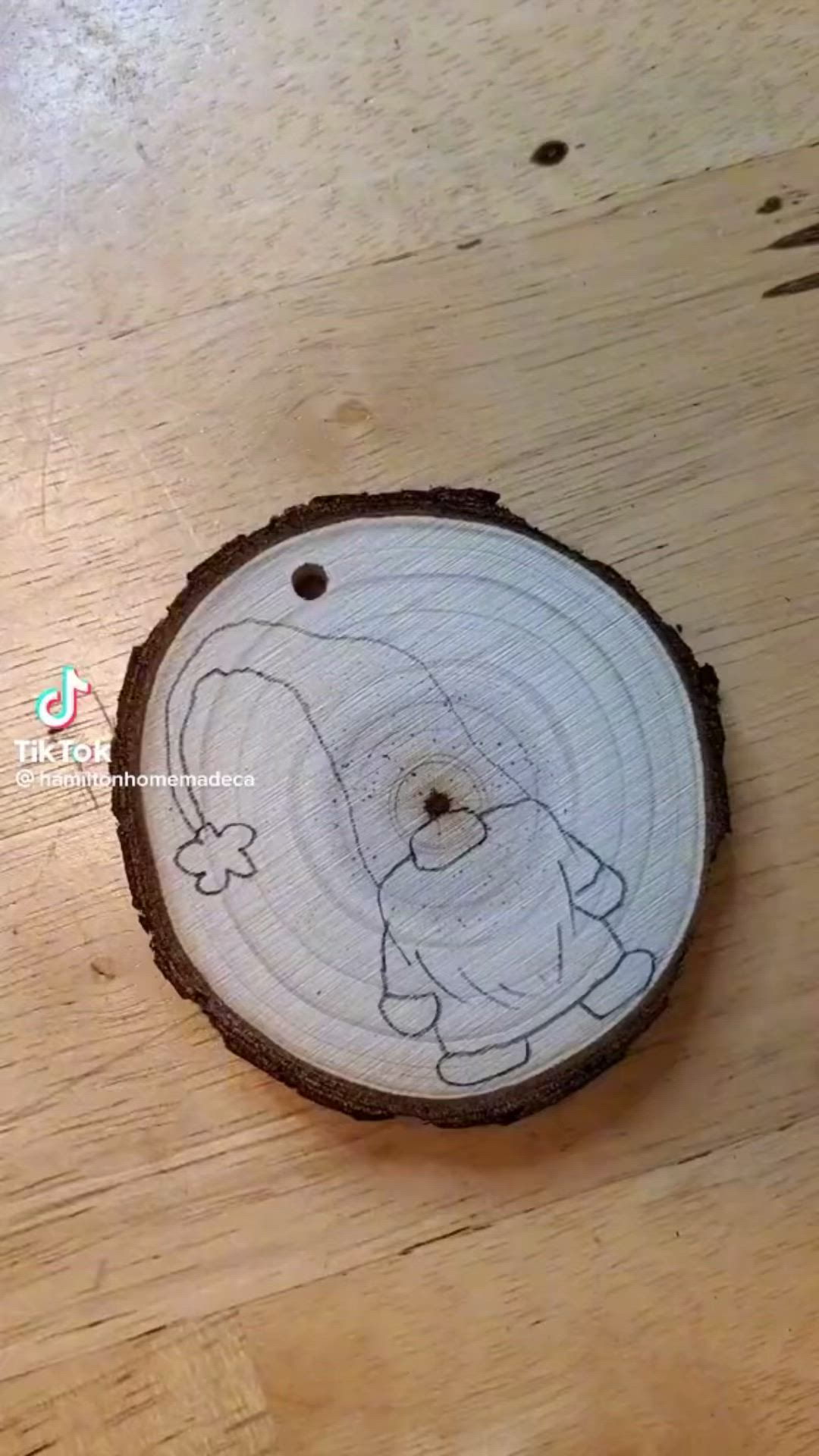 This may contain: a piece of wood with a drawing on it