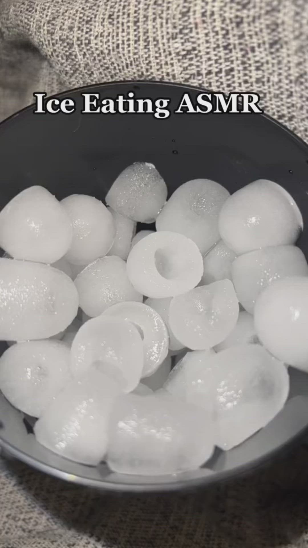 This may contain: ice eating asmr in a black bowl on a white table cloth with the words ice eating asmr above it