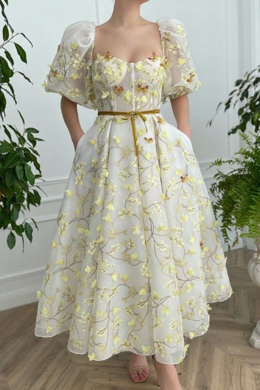 This gorgeous A-line tea-length dress has side pockets, puffy medium sleeves, and a decorative narrow velvet bow belt. It is embellished with embroidered butterflies. The corset has built-in pads and boning for a flattering fit.