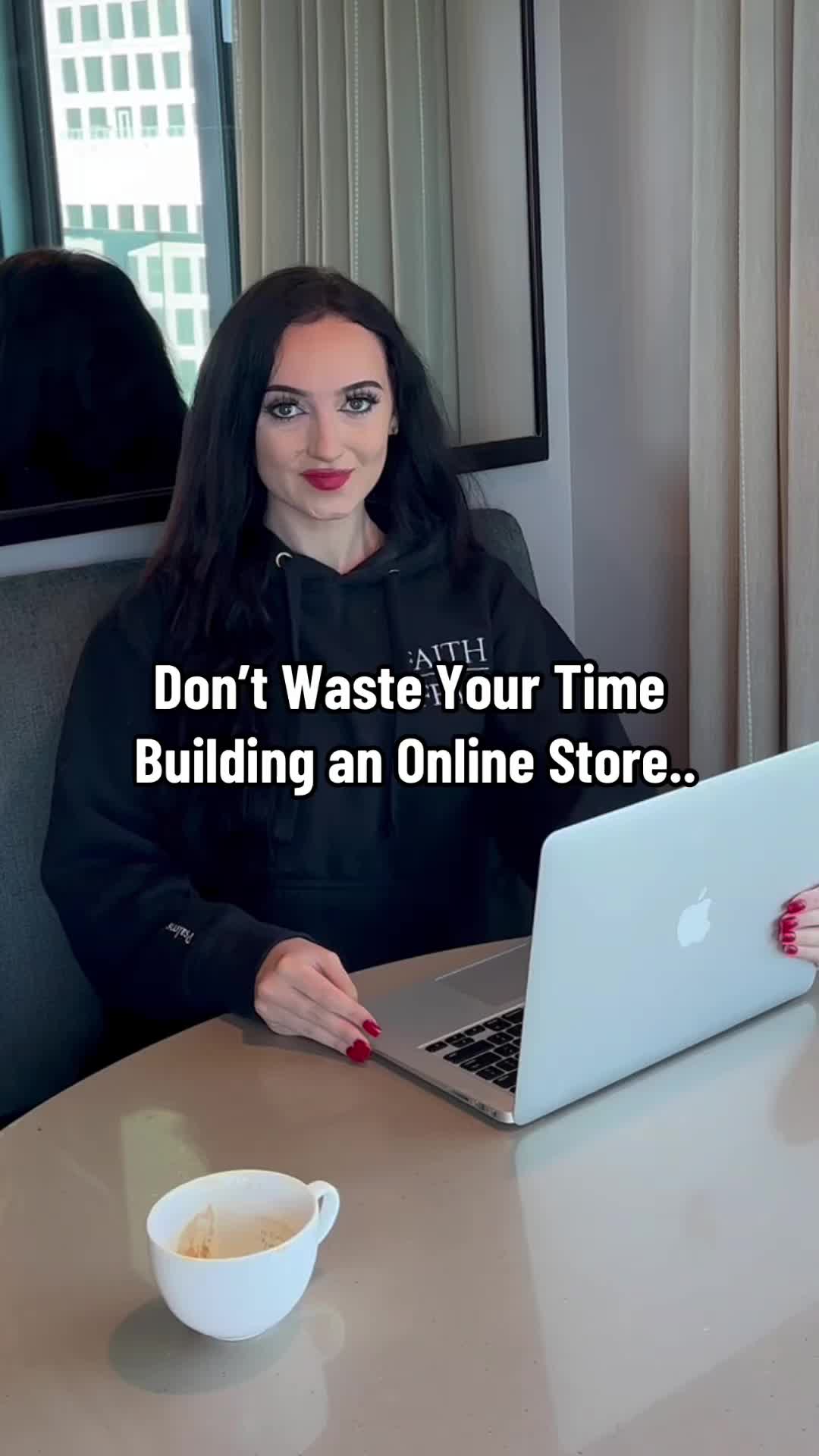 This may contain: a woman sitting at a table in front of a laptop computer with the caption don't waste your time building an online store