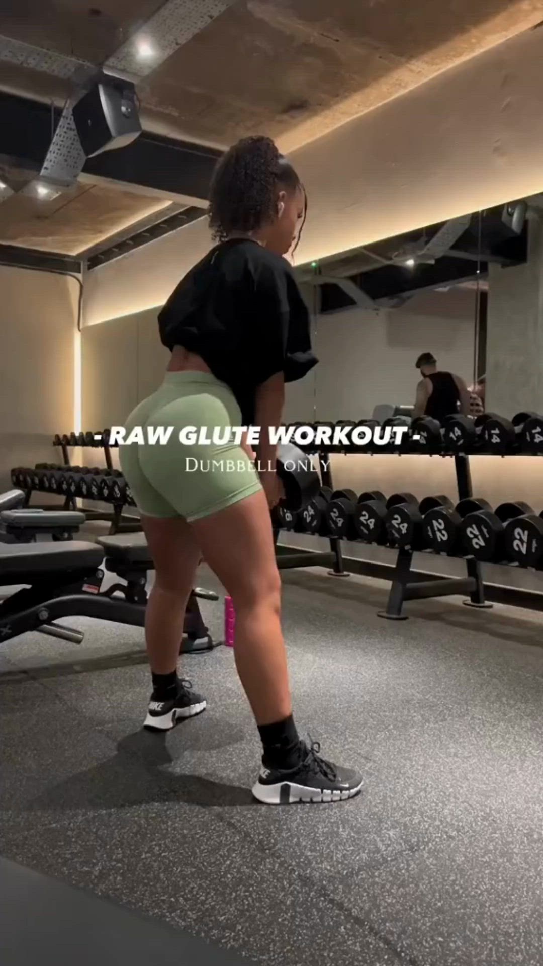 This may contain: a woman standing in front of a row of dumbs with the words raw glute workout