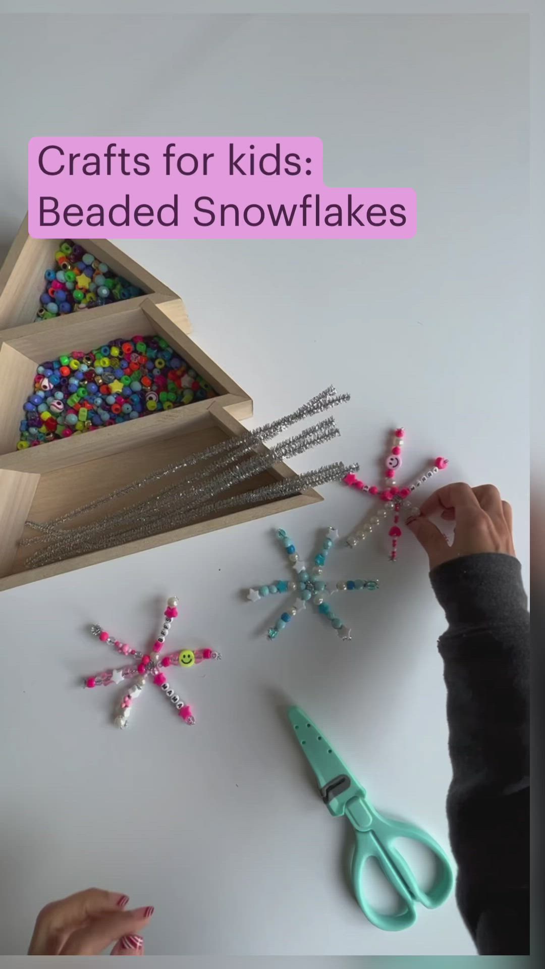 This may contain: a person is making beaded snowflakes out of wood