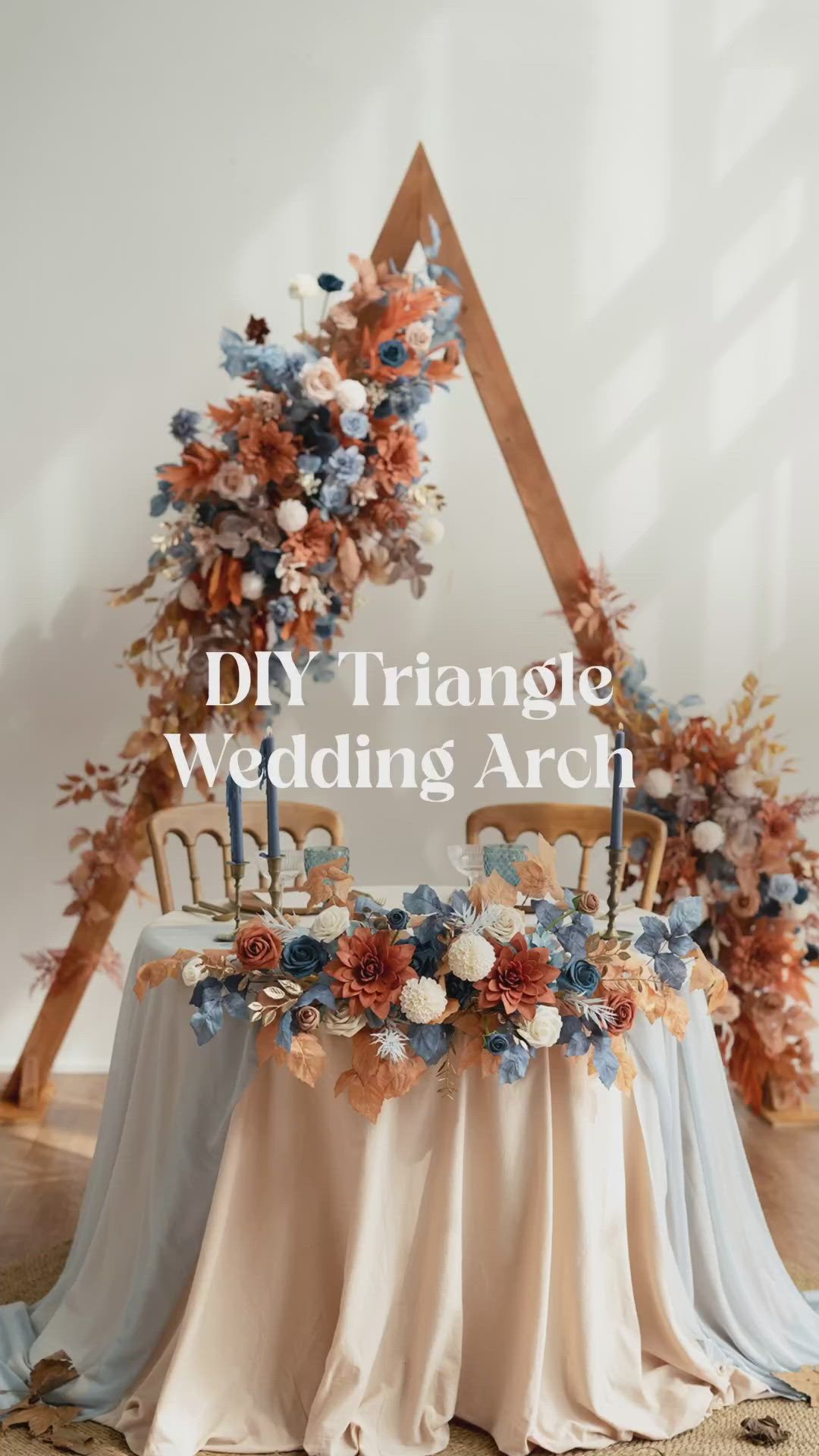 This may contain: an arrangement of flowers and foliage on a table with the words diy triangle wedding arch