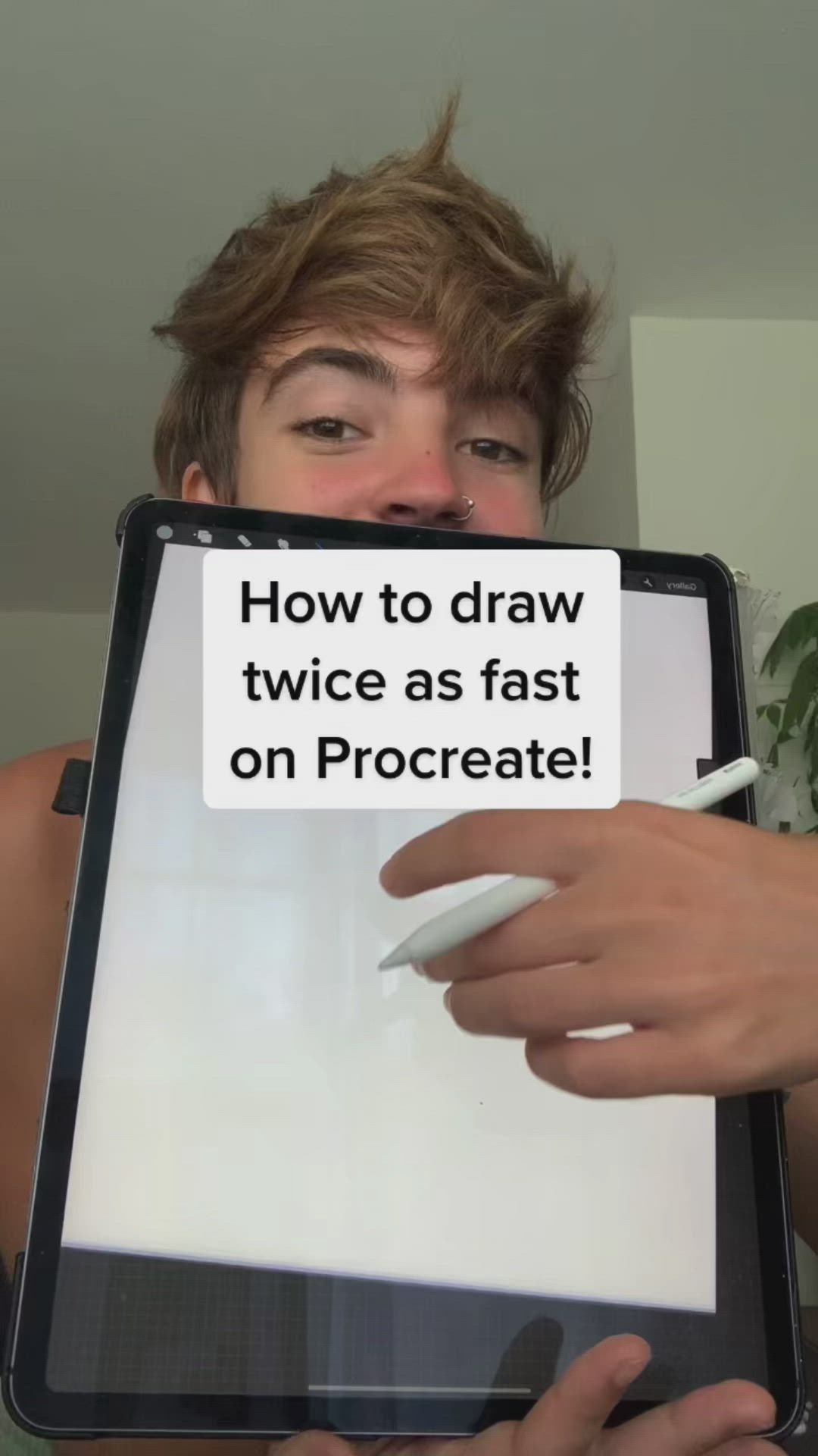 This may contain: a young man holding up a tablet with a sign on it that says how to draw twice as fast on procreate