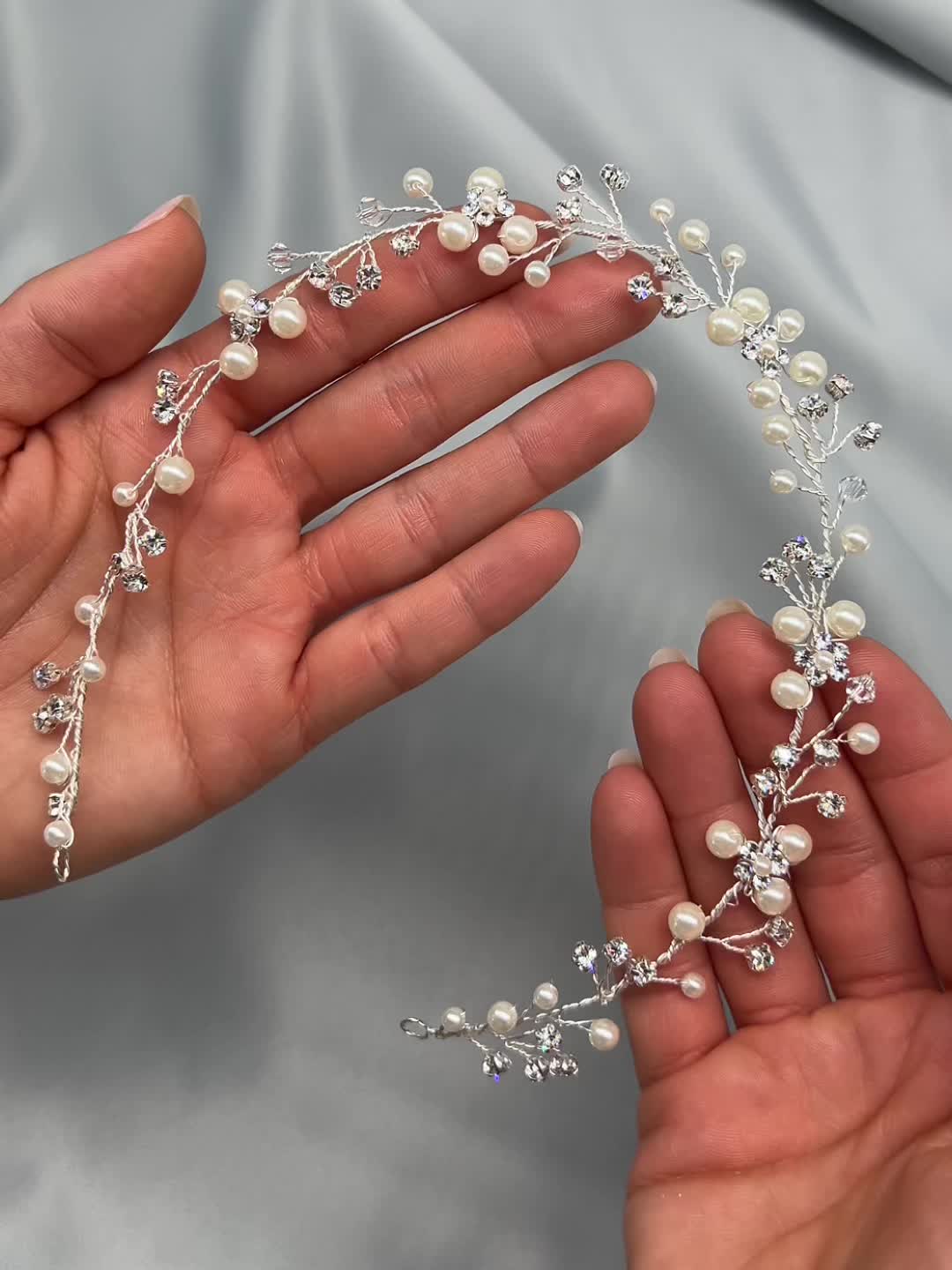 One of our most popular headpieces, our Pretty Floral Hair Vine is perfectly named for its handcrafted pearl bouquets & delicate crystal accents. Lightweight & easy to style. Designed with pearls and crystal gemstones. Measures .5 x 13 inches. Hand wired with off white pearls & crystal gemstones. Pin loops located at each end to secure in your hair with bobby pins. Style #3339 Photo Credit: Natalie Renee Photography