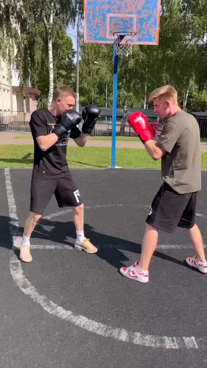 This may contain: two young men are practicing boxing on the basketball court