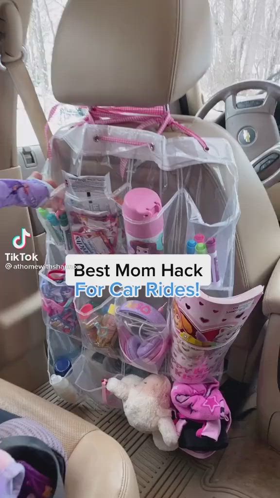 This may contain: the back seat of a car filled with toys and other items for moms to use