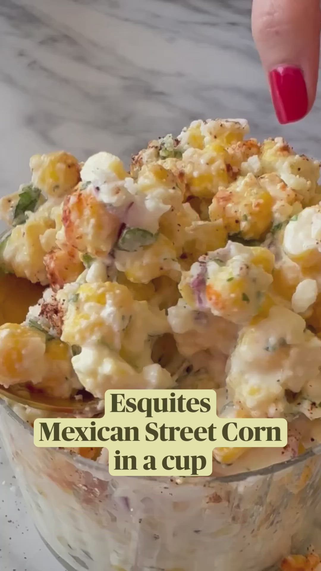 This may contain: a close up of a bowl of food with the words esqquites mexican street corn in a cup