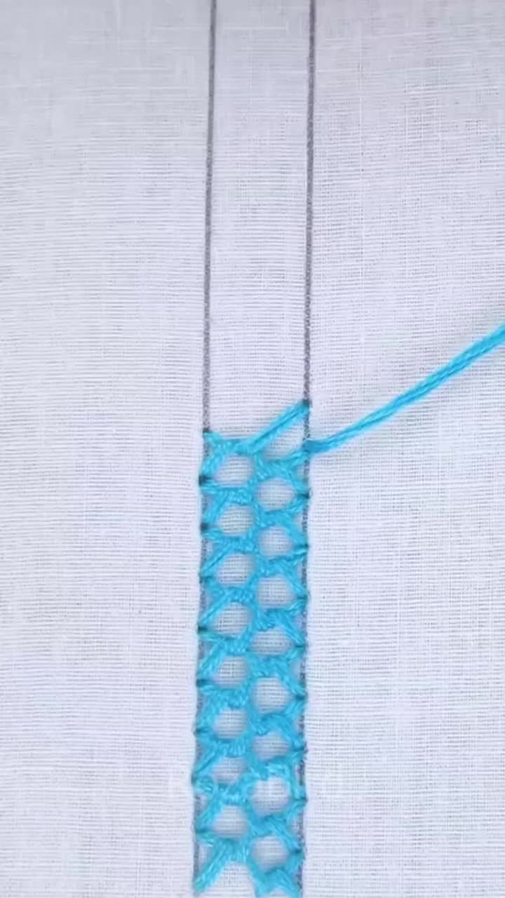 This may contain: a close up of a piece of cloth with a blue thread on it and a white background