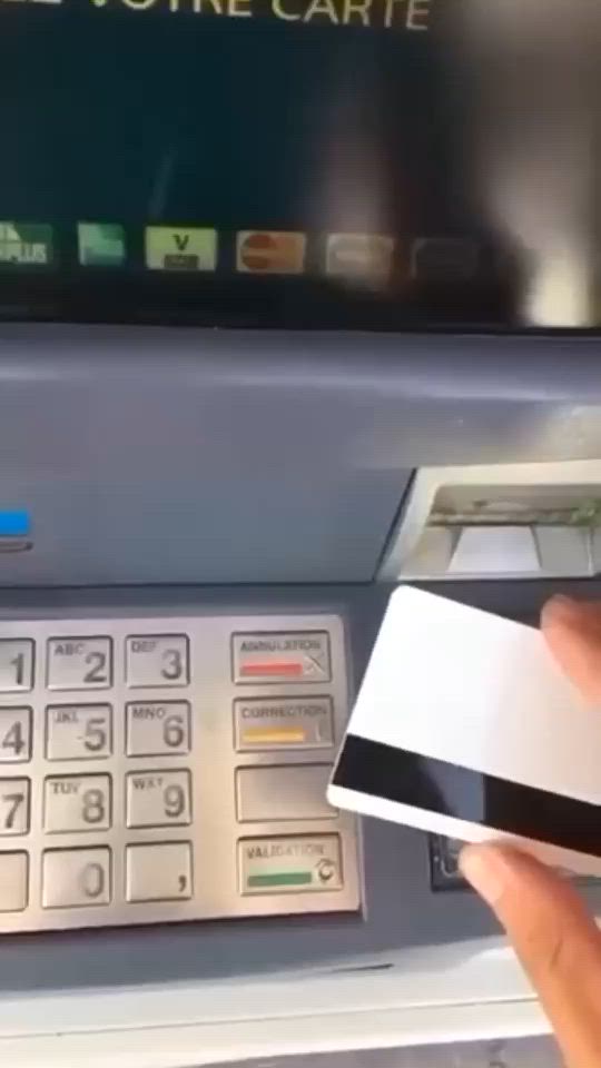 This may contain: a person is using an atm machine to pay for their credit card or other money