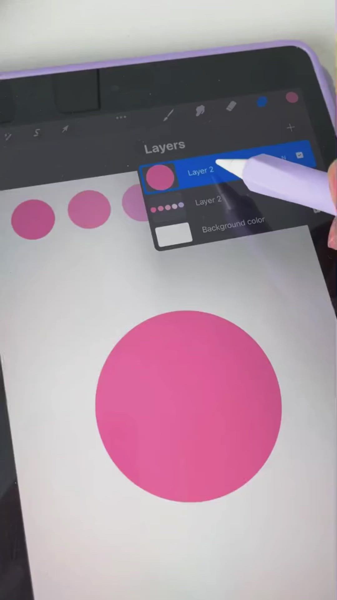 This may contain: a person using a pen to draw on an ipad screen with circles and dots in the background