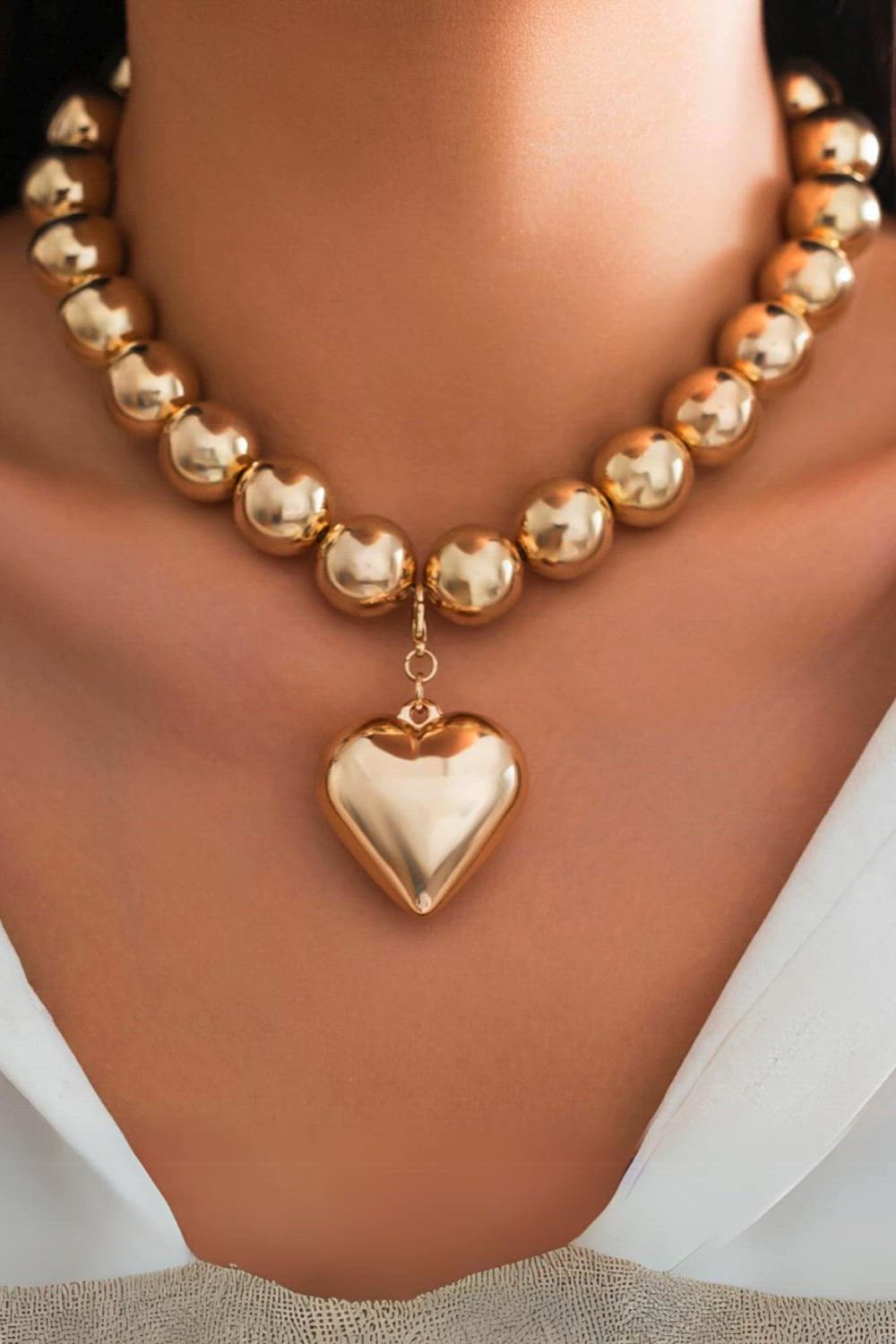 This contains: "Add a touch of bold style to your wardrobe with this Punk Big Love Heart Pendant Choker Necklace. The vintage chunky CCB beads chain and grunge-inspired design make a statement while the heavy construction ensures durability. Perfect for anyone looking for unique, steampunk jewelry."