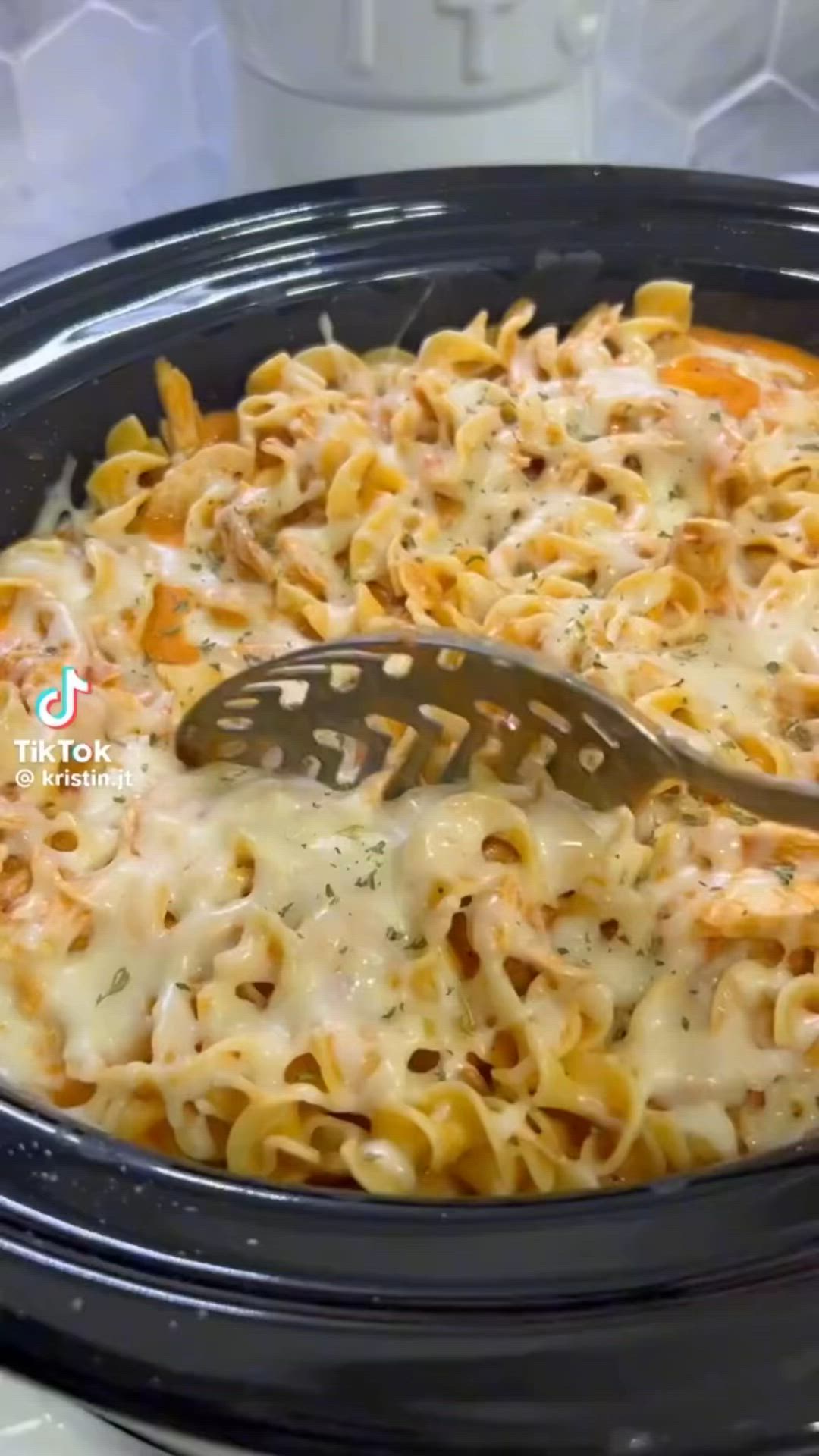 This may contain: a close up of a casserole dish with a spoon in it