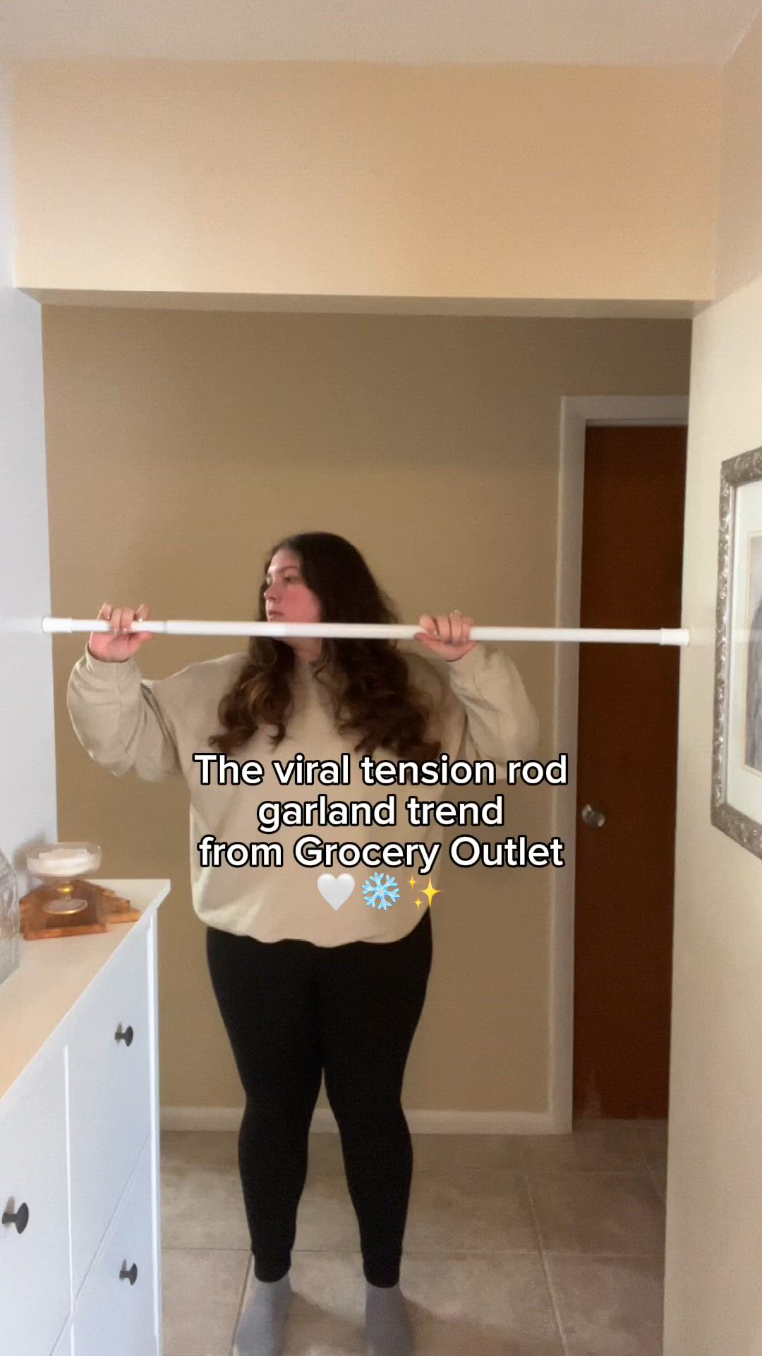 This may contain: a woman standing in front of a bathroom mirror holding a tape over her face with the words, the virtual tension road grand trend from grocery outlet