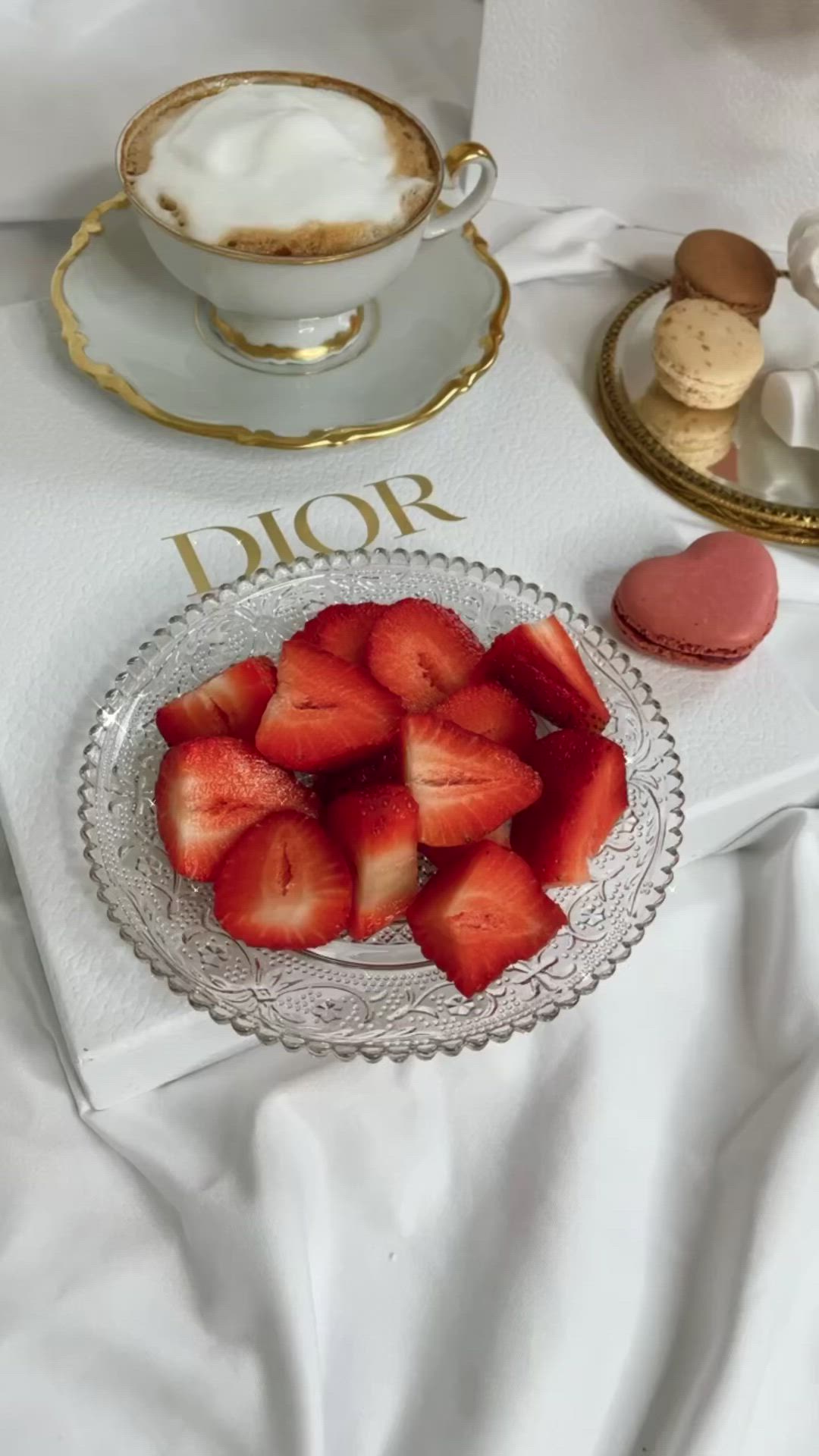 This may contain: a table topped with desserts and pastries on top of a white table cloth