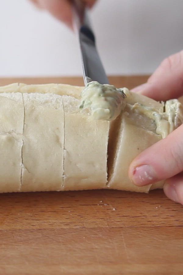 This may contain: a person is cutting bread with a knife