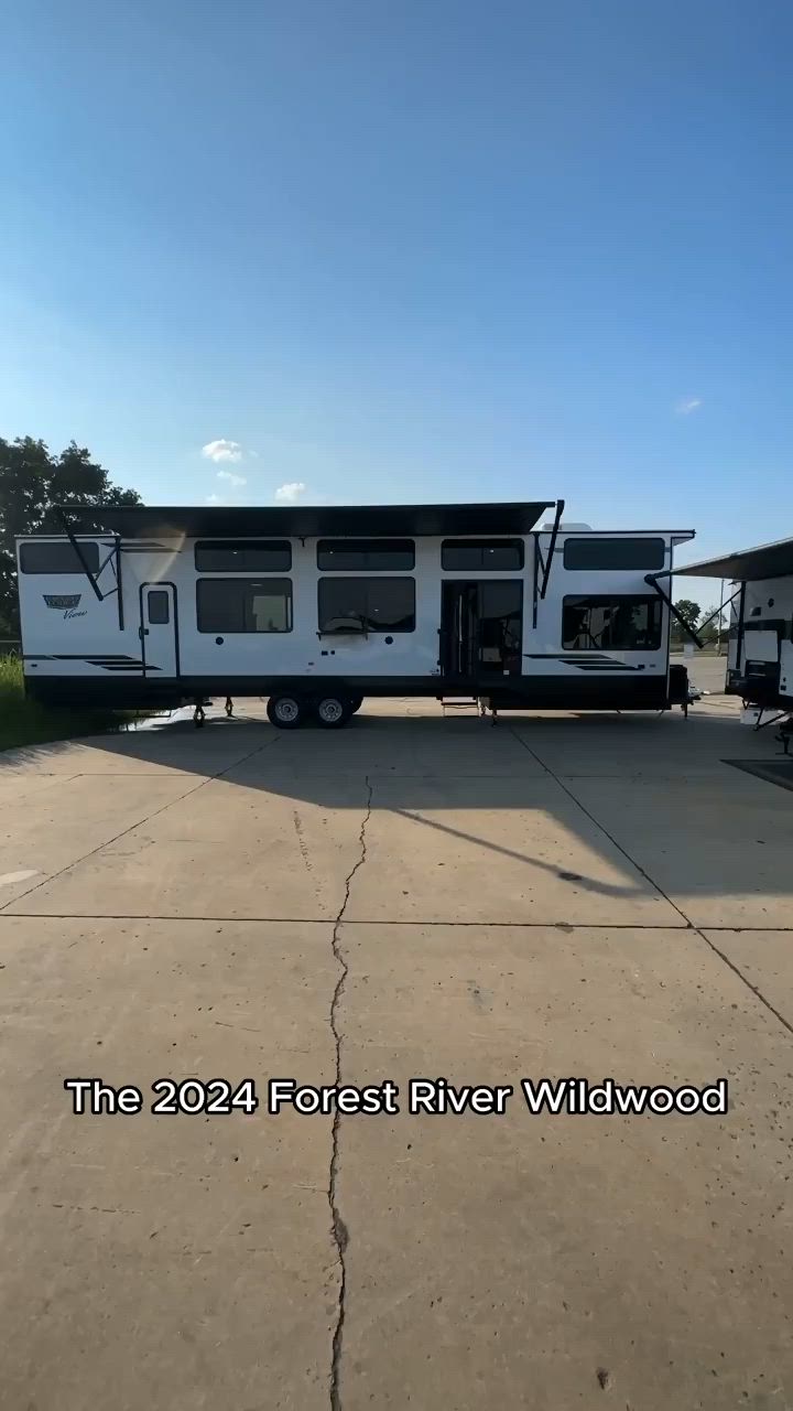 This may contain: a white rv parked on top of a cement road