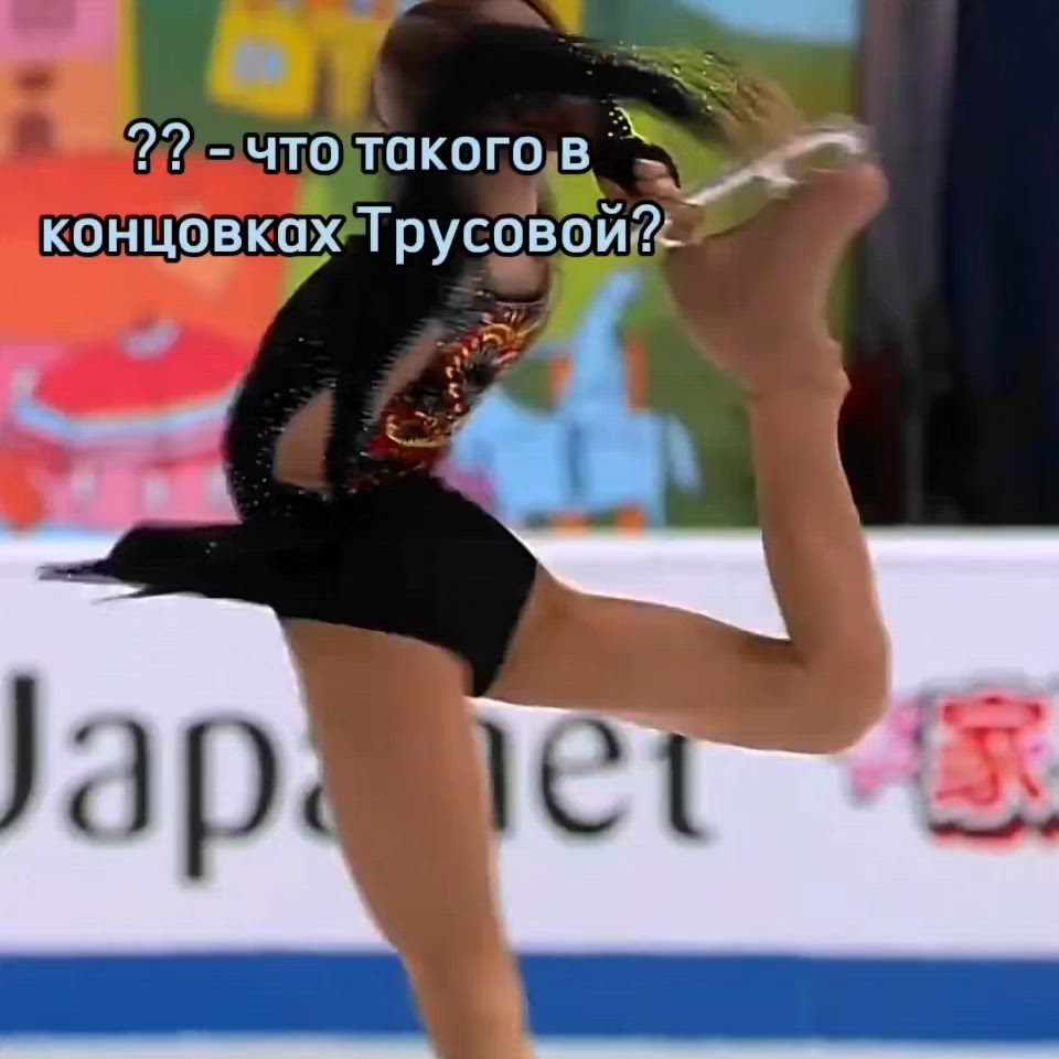 This may contain: a woman skating on an ice rink in front of a sign that reads,?????????????????????????????????????????