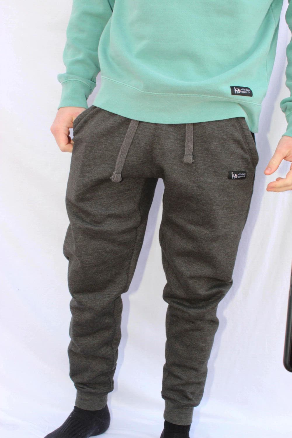 This contains: Here are a person wearing grey sweatpants