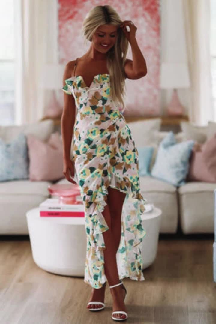 You'll be a vision in this dress! We love the asymmetrical flow of the skirt. The floral print and ruffle detailing are stunning! Fit: True to size. Model is 5'6 wearing size small.