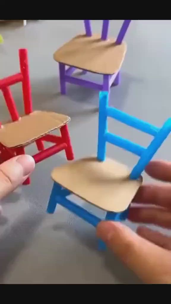 This may contain: someone is playing with miniature chairs in the room