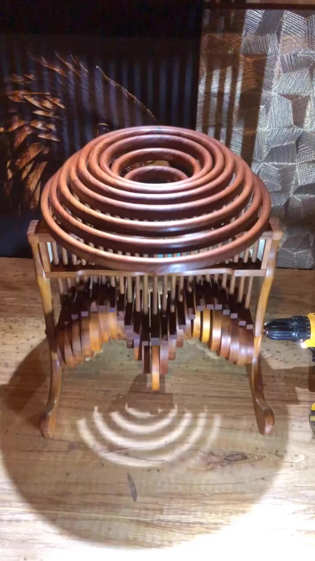 This may contain: a sculpture made out of wooden spirals sitting on top of a table