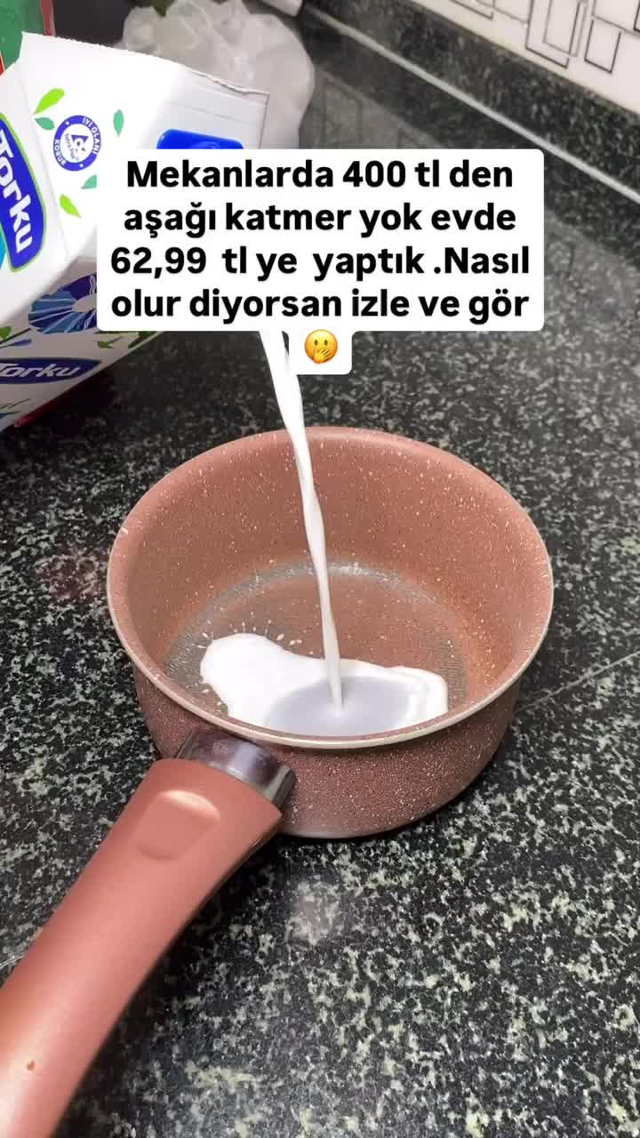 This may contain: milk being poured into a frying pan on top of a kitchen counter with an empty carton of milk in the background