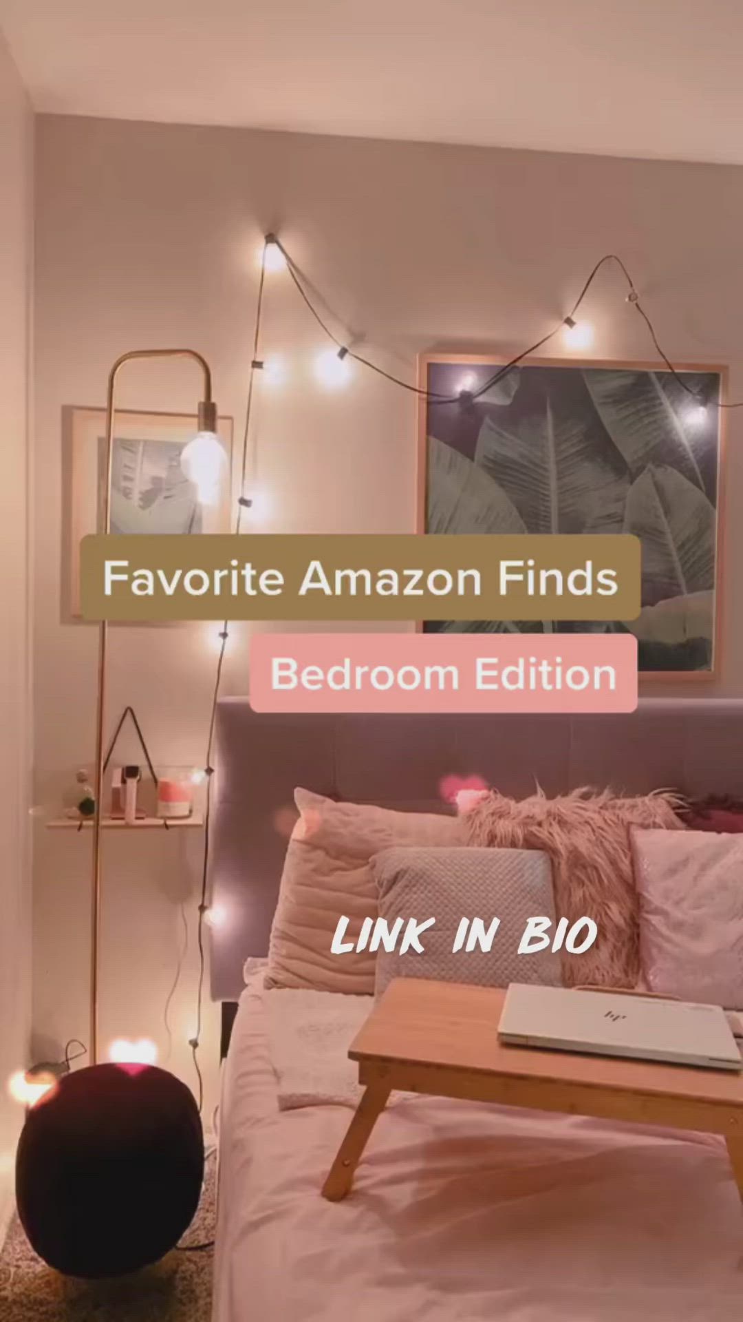 This may contain: a bed room with a neatly made bed and some lights on the wall above it