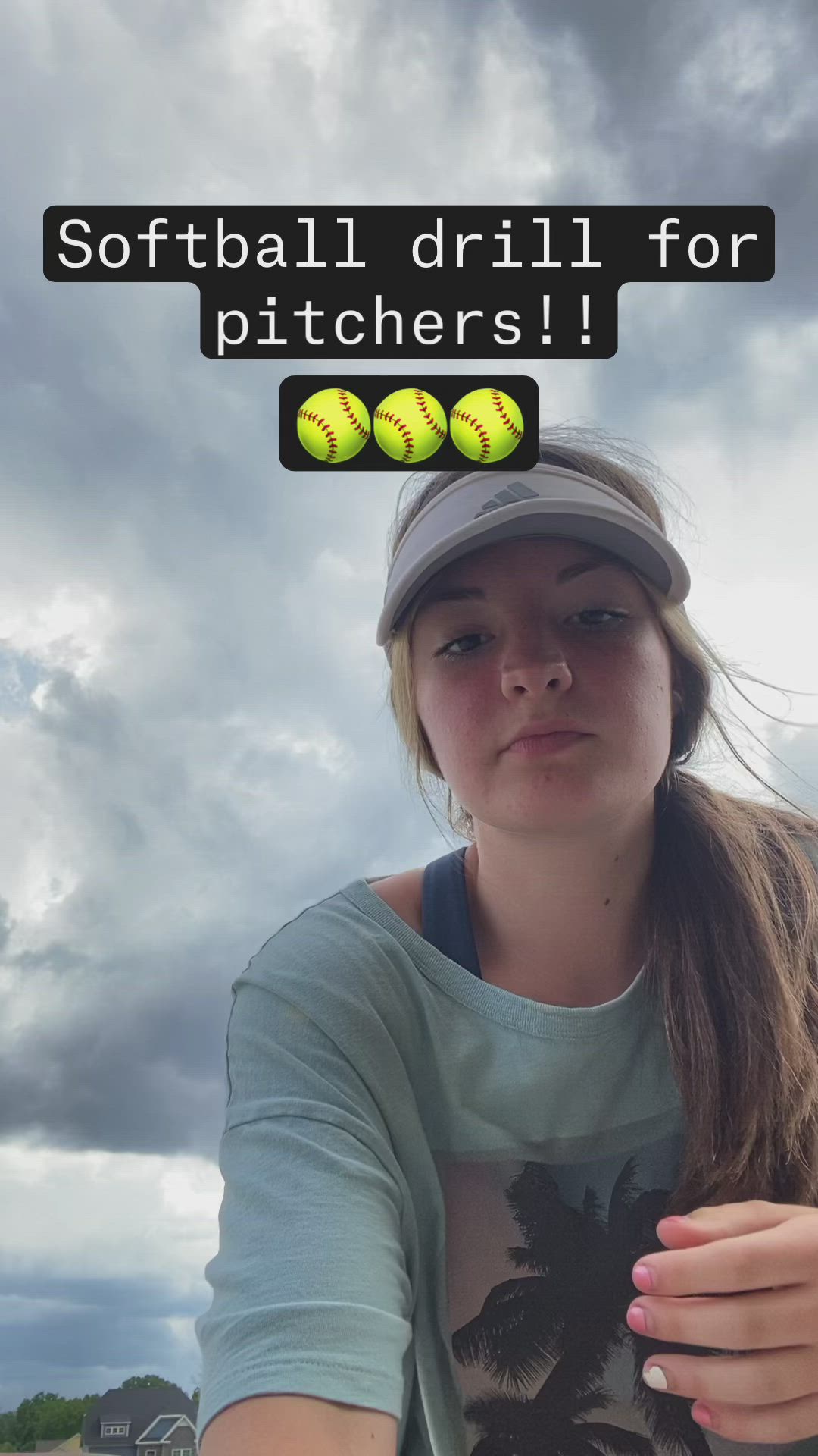 This may contain: a woman holding two tennis balls in one hand and the words softball drill for pitchers above her head