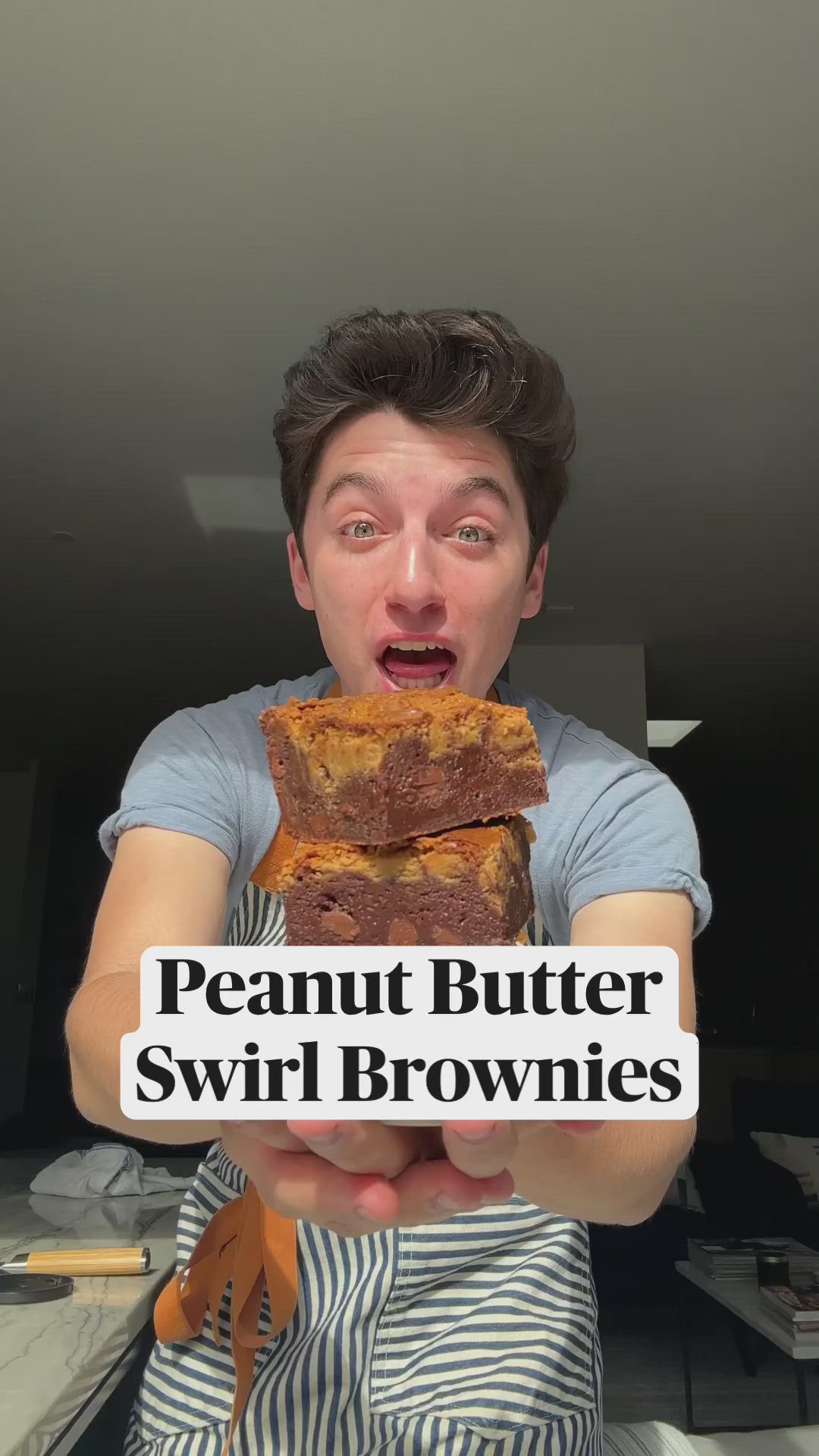 This may contain: a man holding two pieces of bread in his hands with the words peanut butter swirl brownies on it