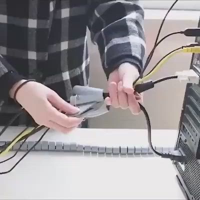 This may contain: two hands holding wires connected to a computer