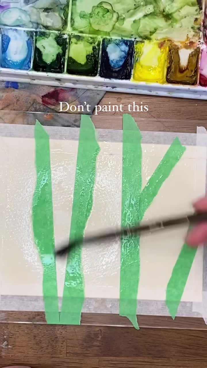 This may contain: someone is painting trees with watercolors on the table