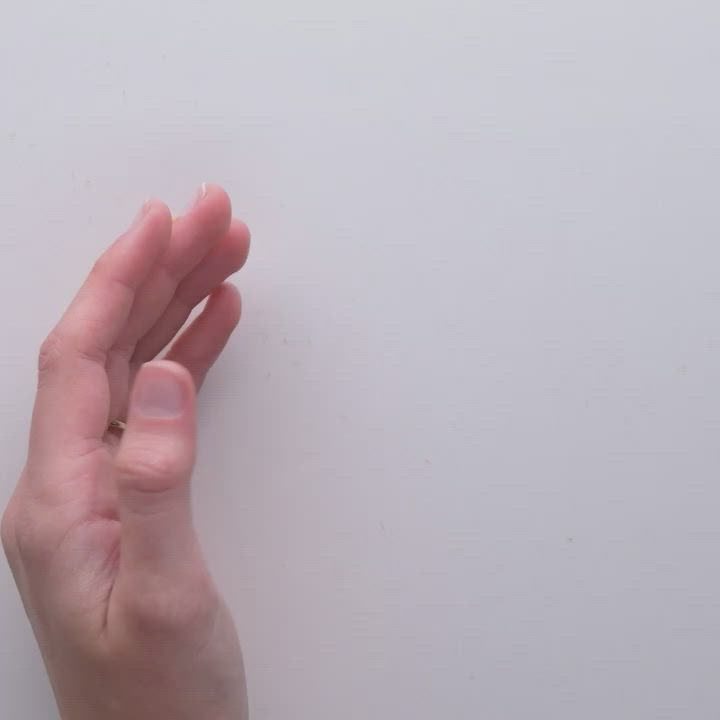 This may contain: a person's hand reaching up to touch the wall with their index and index fingers