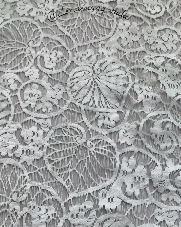 This may contain: an image of white lace with flowers on it