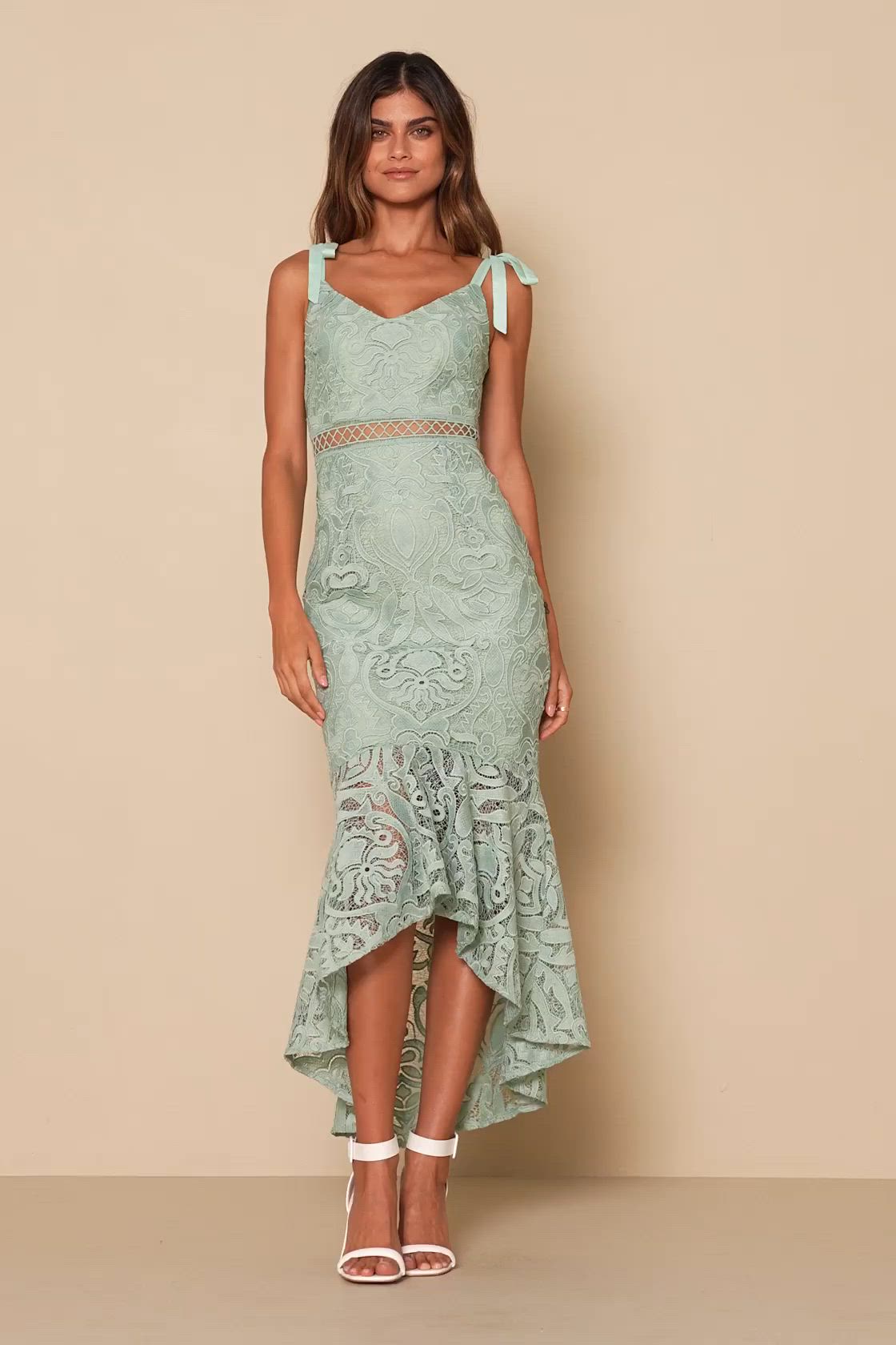 The Lulus Won Your Heart Sage Green Lace Tie-Strap High-Low Midi Dress is full of romance, so it's no wonder we're swooning! Lovely embroidered lace creates a V-neckline and a darted bodice, all supported by tying straps. A panel of sheer crochet lace creates the fitted waist above a figure-skimming midi skirt that ends in a high-low trumpet hem. Hidden back zipper/clasp. Fit: This garment fits true to size. Length: Knee to mid-calf length. Size medium measures 46" from adjustable straps to hem.