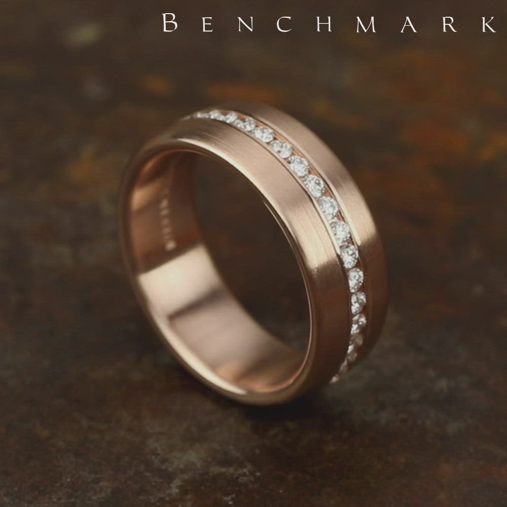 This may contain: a rose gold wedding ring with white diamonds