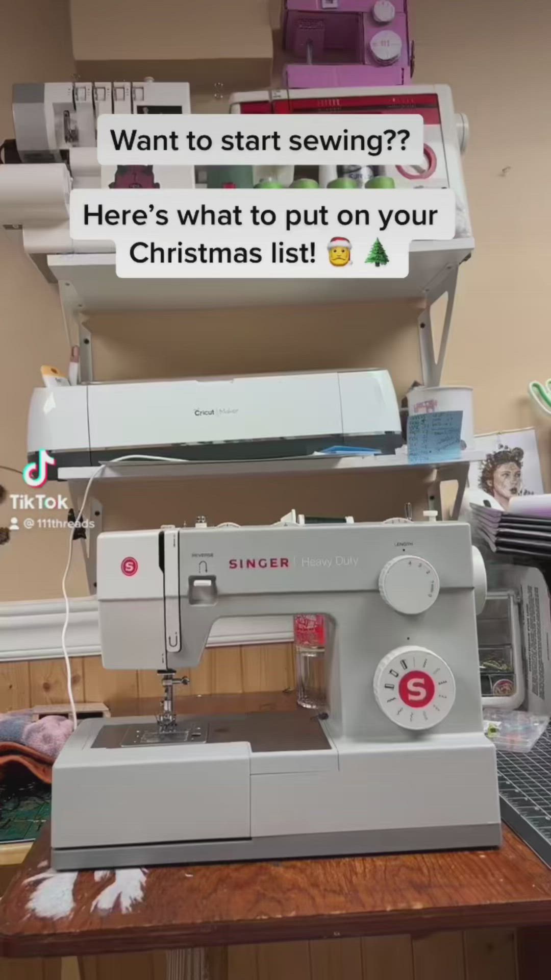 This may contain: a sewing machine sitting on top of a wooden table next to a shelf filled with other items