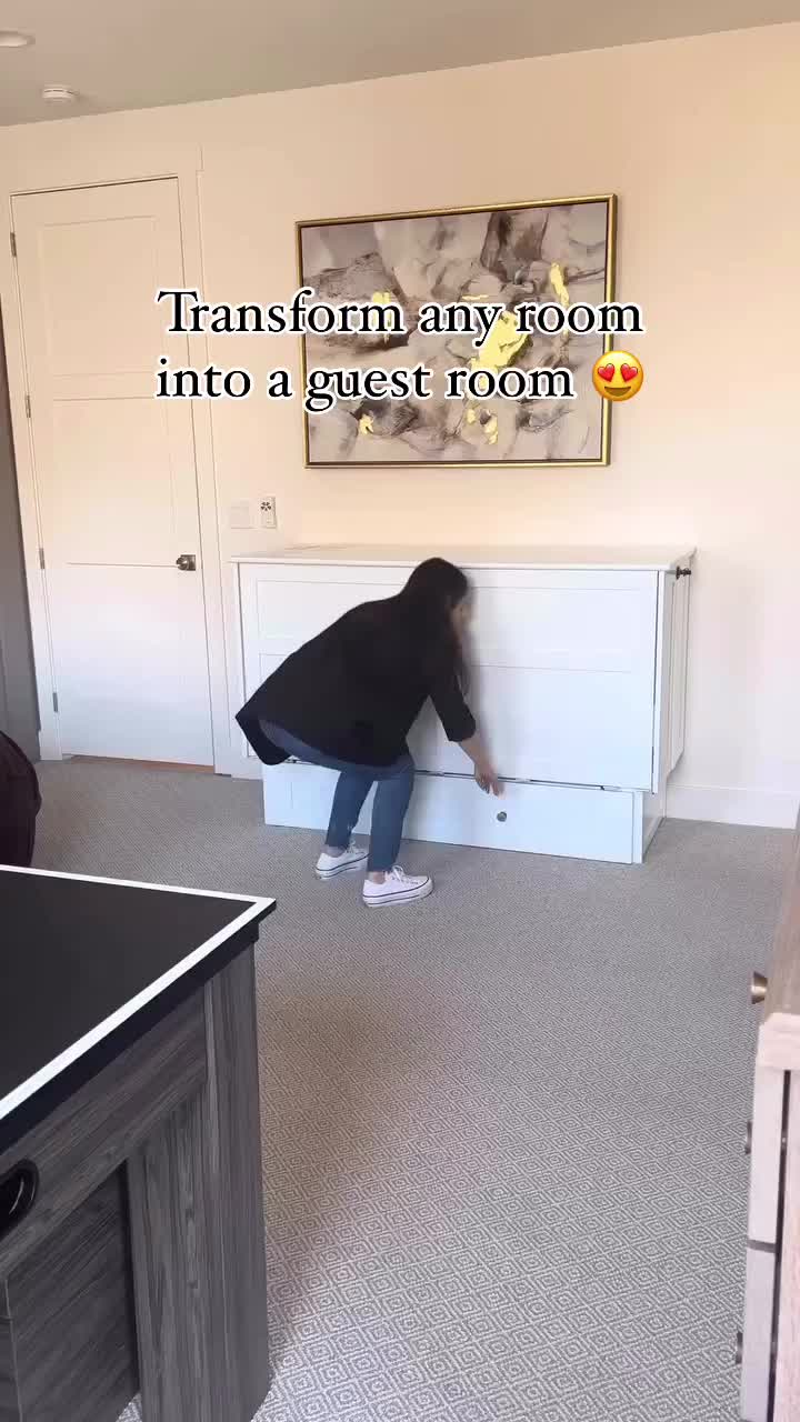 This may contain: a woman standing in front of a white bed frame with drawers on each side and the words transform any room into a guest room