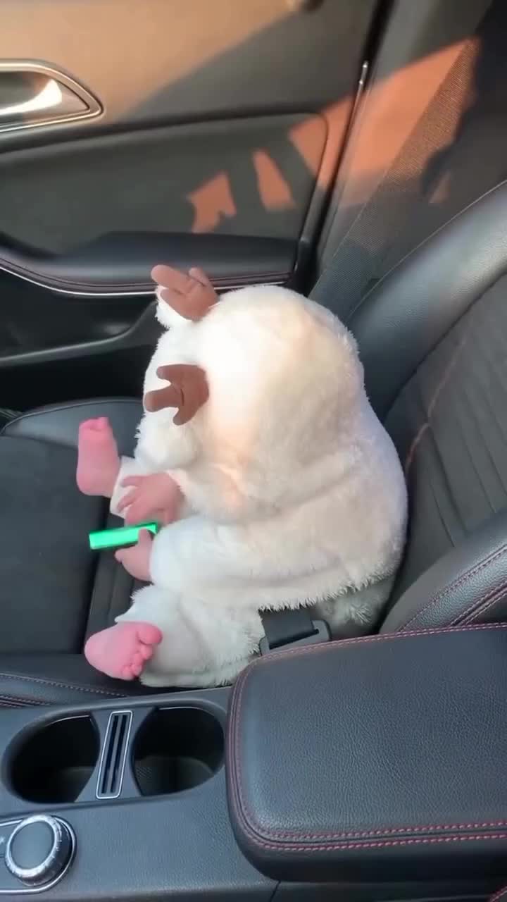 This may contain: a stuffed animal sitting in the passenger seat of a car with toothbrushes in it's mouth