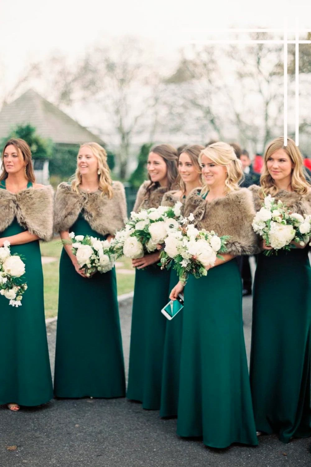 This may contain: bridesmaids in green dresses and fur vests stand together on the side of the road