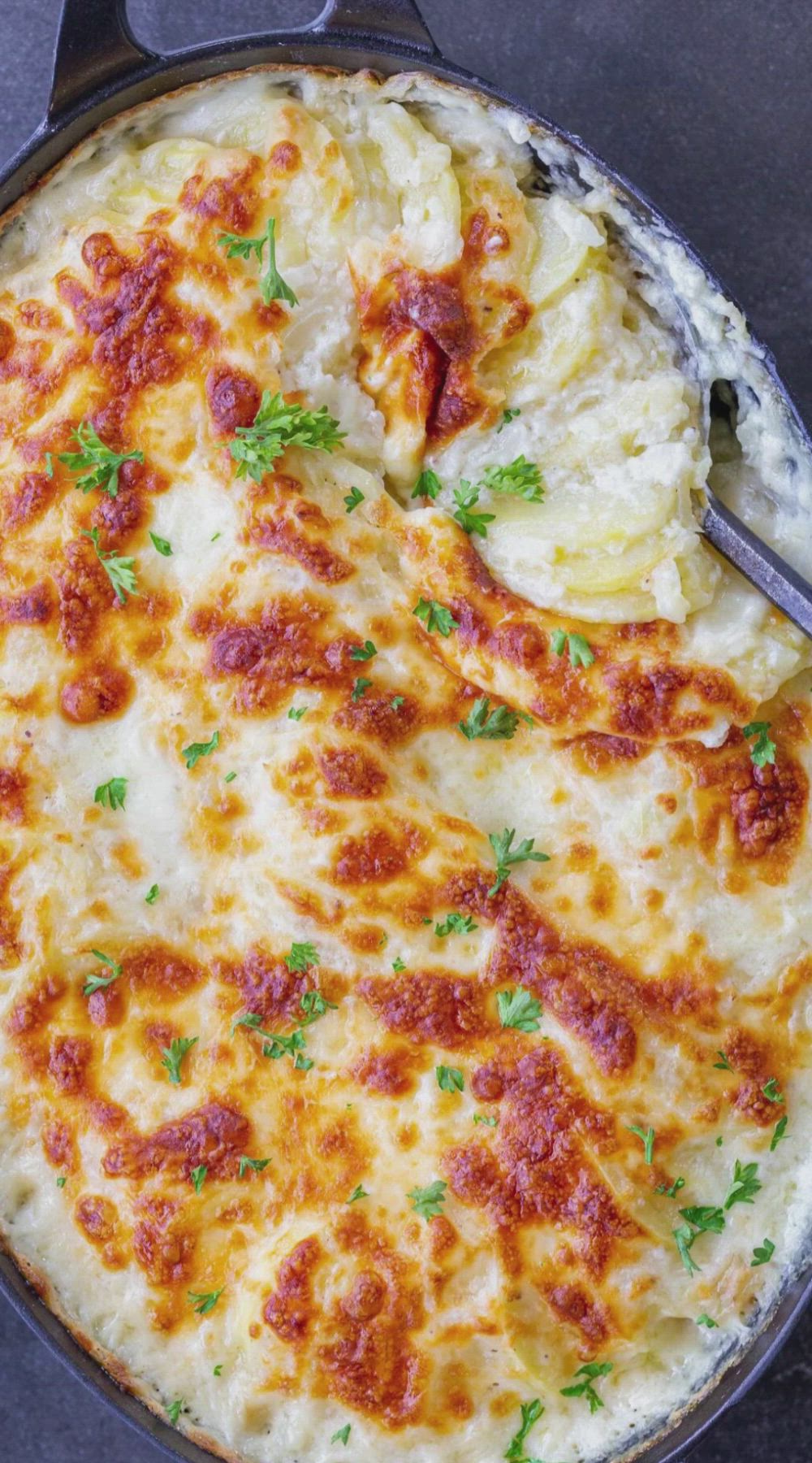 This may contain: the best scalloped potatoes recipe in a skillet with text overlay that reads how to make the best scalloped potatoes