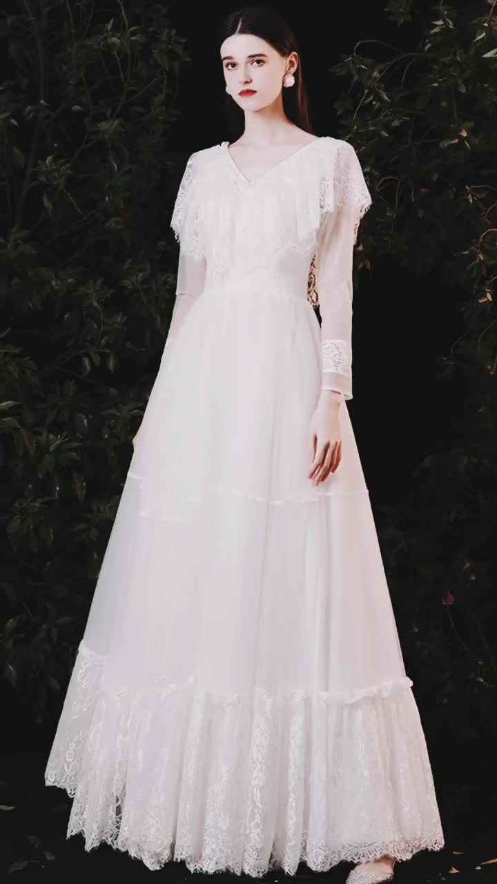 This contains: Romantic Lace Vneck Boho Wedding Dress with Sheer Long Sleeves