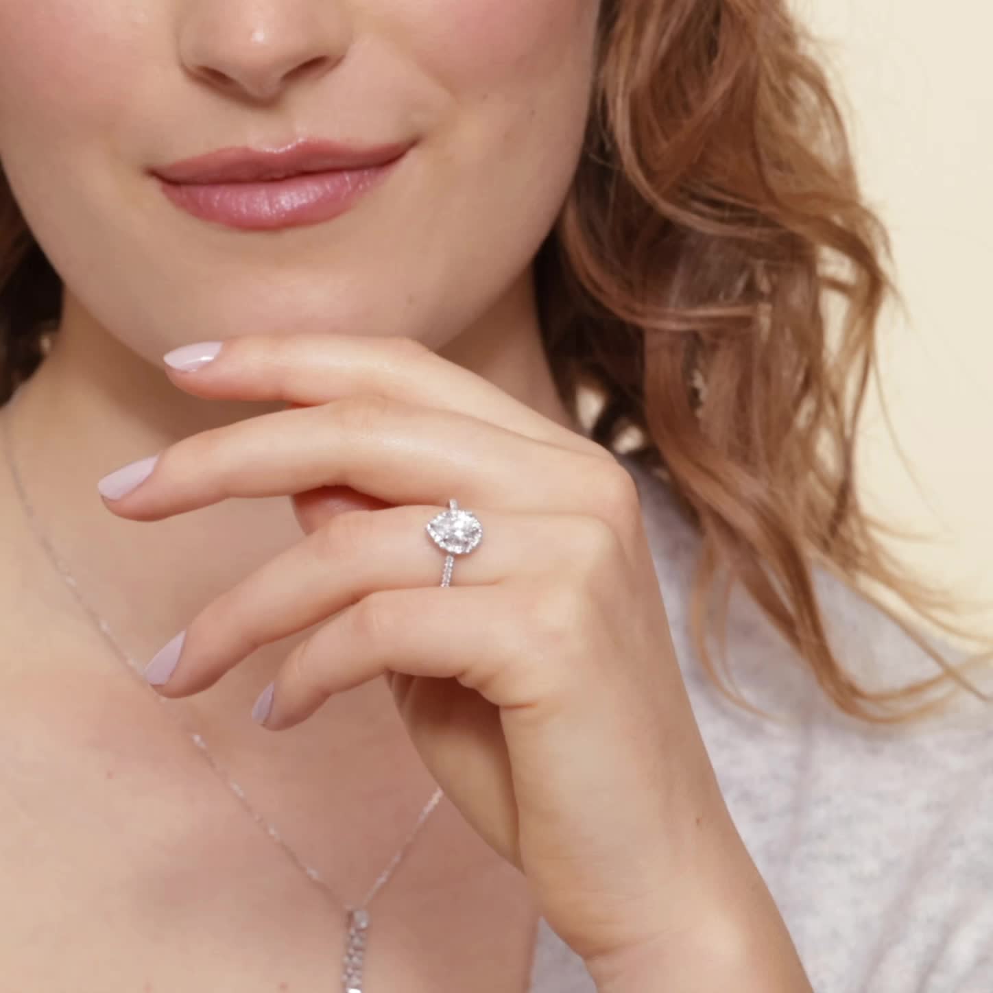 This may contain: a close up of a person wearing a necklace and ring with a diamond on it