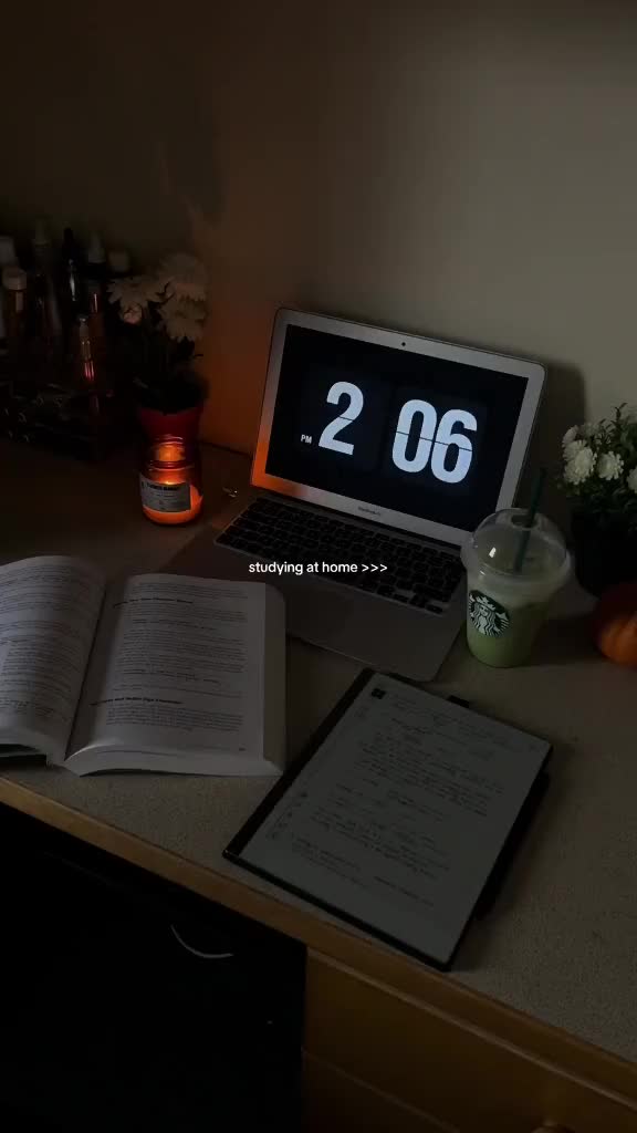 This may contain: an open laptop computer sitting on top of a desk next to a calculator